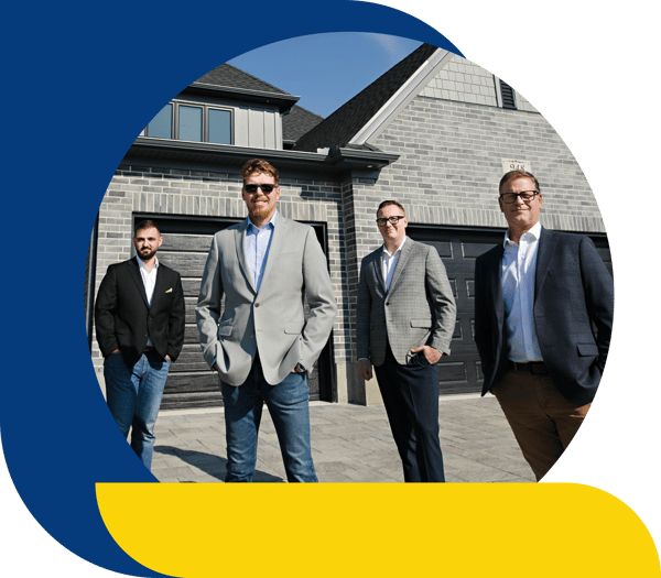 Team in front of house